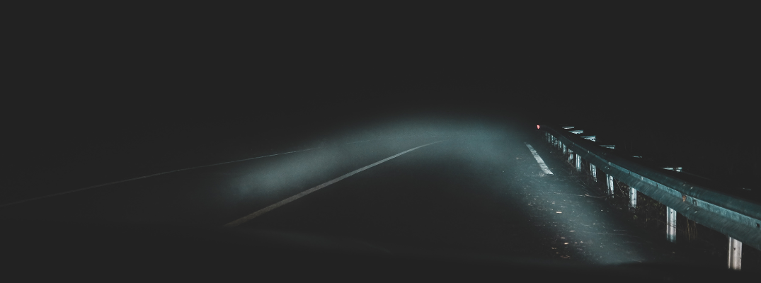 Dim headlights on a dark road